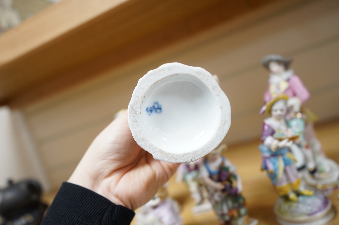 Eight various German porcelain figures, some with crossed sword marks to the bases and a floral encrusted pot and cover, largest 19cm high. Condition - fair, some losses